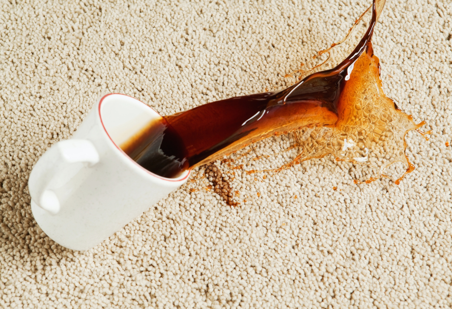 coffee mug spilling on tan carpet